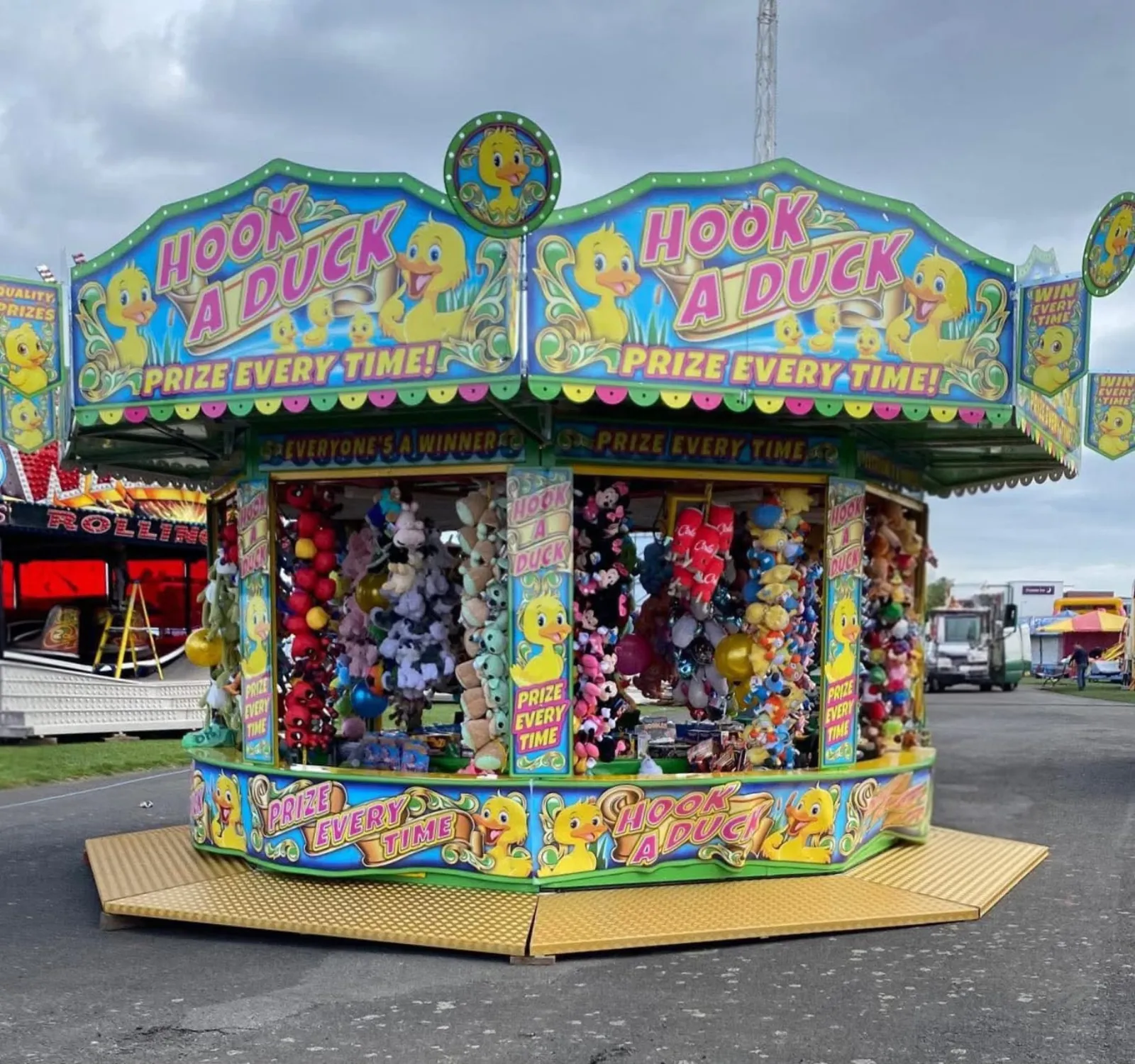 Colourful Hook a Duck fairground stall stocked with soft toy prizes
